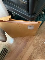 Manila envelope holding prints