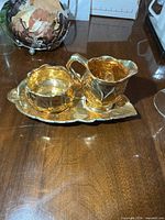 Cream pitcher, sugar bowl and tray grouped on tabletop