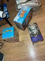 Three boxed VHS sets on floor