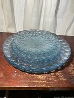 Stack of all eight blue glass Bubble plates