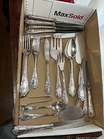 Full view of box with forks, knives, serving pieces