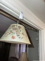 Full view of hanging lamp showing floral design and chain