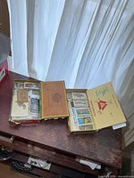 Both open cigar boxes showing large quantity of vintage cards inside