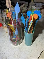 Overview of both containers filled with colourful swizzle sticks