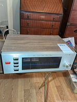 Front and top view of tuner showing overall design and wood-grain cabinet