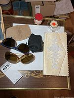 overall lot showing clutch, two sunglasses, beige wallet, black coin purse, perfume bottles