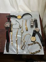 Group shot of all watches and bracelet laid out