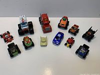 All 12 toy vehicles arranged on white background
