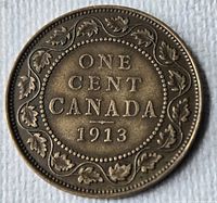 Reverse of 1913 Canada one cent coin displaying denomination, country and date within maple-leaf wreath