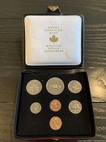 Open case showing six coins and inner liner