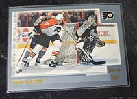 Front view of 2000-01 O-Pee-Chee John LeClair hockey card in protective sleeve