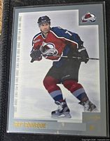 Front view of 2000-01 O-Pee-Chee Ray Bourque trading card in protective sleeve