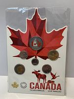 Front view of sealed coin set on maple-leaf card showing all six coins