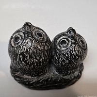 Front view of twin owl figurine showing silver antiqued finish