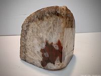 Front angled view showing polished face, quartz center, jasper inclusion, and rough top edge