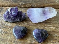All four amethyst pieces on wood surface