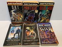 Front covers of the six paperback novels displayed in two rows