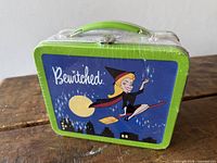 Front view showing shrink-wrap, handle, broomstick graphic