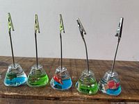 Front view of five resin sea life card holders