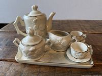 Assembled child’s tea set on tray