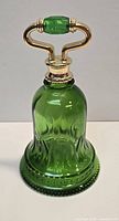 Full view of green glass bell decanter showing body and metal handle
