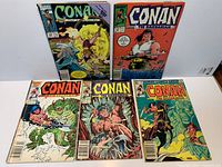 Group shot of all five Conan the Barbarian comic issues spread on surface