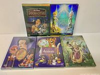 Front view of five sealed Disney DVD cases arranged in two rows