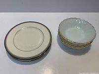 Stacked plates and bowls showing quantity and general condition