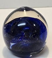 Front view showing cobalt blue swirl core and clear glass body