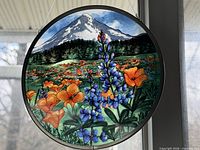 Front view of round scenic glass hanger in window