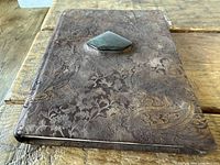 Front view of embossed leather address book with gemstone inset
