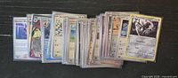 Front view of entire stack of sleeved Japanese Pokémon cards spread out showing variety