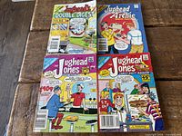 All four Jughead digest comic books laid out on wooden surface, full covers visible