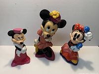Front view of three Minnie Mouse resin/plastic figures standing side-by-side