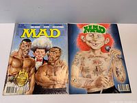 Front covers of both MAD magazines laid flat
