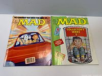 Both MAD magazines side by side showing covers