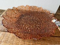 Top view of marigold carnival glass bowl showing full filigree pattern