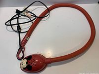 Full view of red flexible Mickey Mouse lamp with power cord