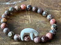 Full view of beaded bracelet showing jasper beads and sloth accent