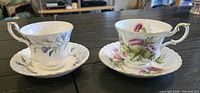 Front view of both teacup and saucer sets showing patterns