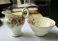 Creamer and sugar bowl side view showing floral decoration and gilt trim
