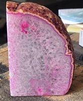 Reverse crystalline quartz interior with pink overtones and rough brown rind on top edge