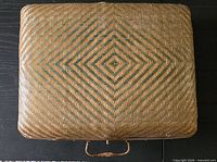 Closed rattan suitcase top view showing diamond pattern