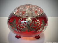 Cranberry glass posy bowl with silver overlay and clear glass frog, frontal view showing feet and design