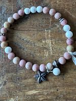 Full view of bracelet showing bead pattern and charms