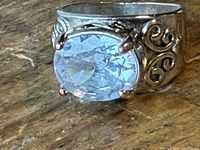 Ring angled view showing stone and scrollwork