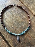 Entire necklace laid flat showing bead arrangement and pendant