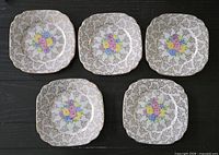 Five square bone china plates front view