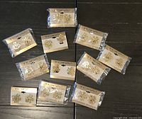Twelve packaged pairs of TOFA gold-tone Jesus stud earrings