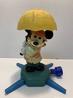 Full view of Mickey Mouse sprinkler with umbrella and four-leg base